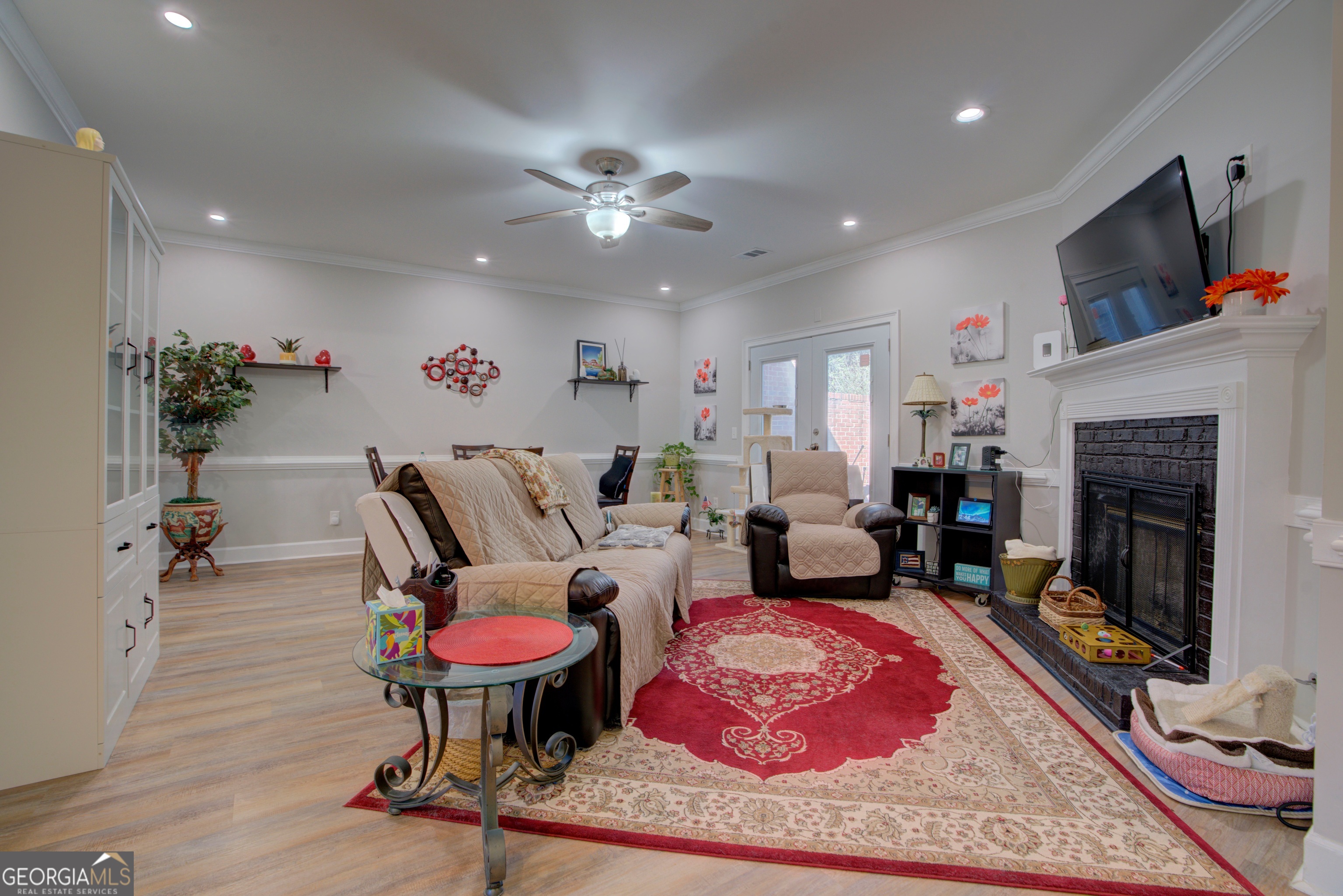 814 Manor Way Cartersville, GA 30120 - Photo 10 of 24 a living room with furniture a fireplace and a flat screen tv