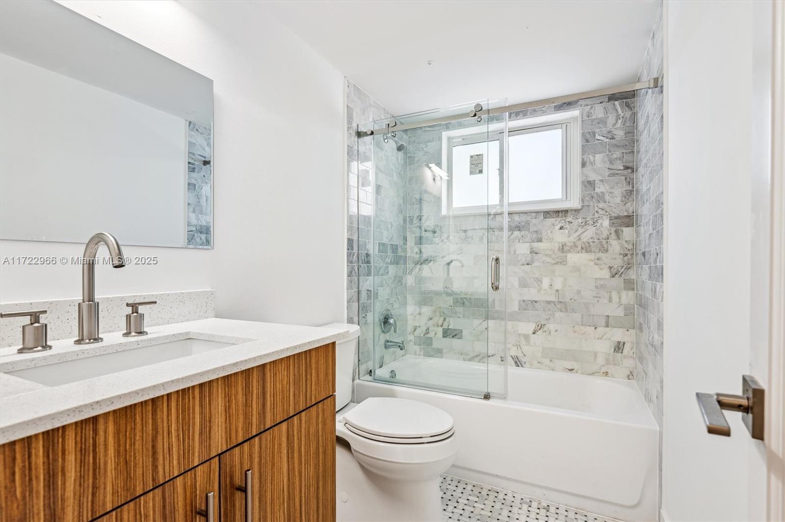 301 Sunrise Drive, Unit 3AW Key Biscayne, FL 33149 - Photo 11 of 23 a bathroom with a sink a toilet and shower
