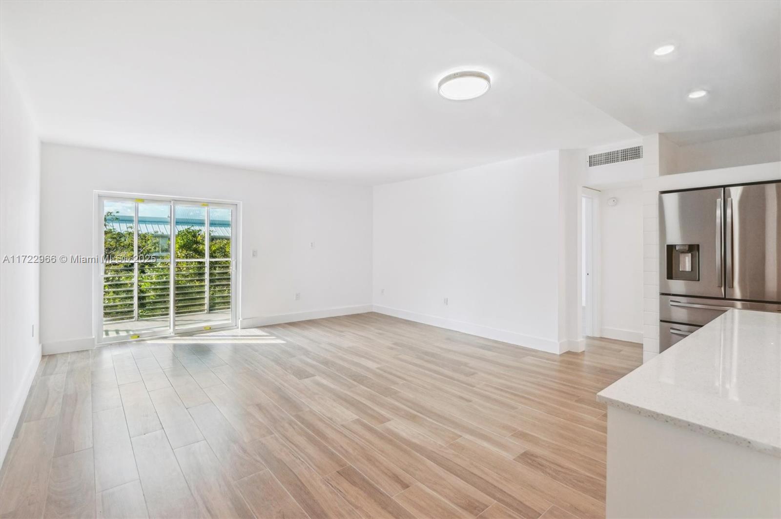 301 Sunrise Drive, Unit 3AW Key Biscayne, FL 33149 - Photo 12 of 23 a view of a kitchen with wooden floor and a window