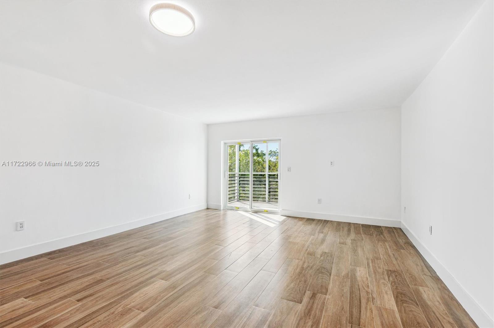 301 Sunrise Drive, Unit 3AW Key Biscayne, FL 33149 - Photo 14 of 23 an empty room with wooden floor and windows