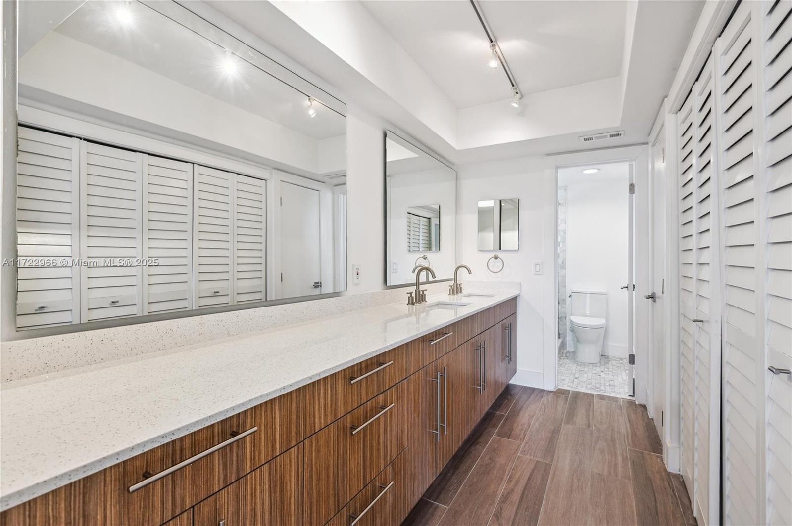 301 Sunrise Drive, Unit 3AW Key Biscayne, FL 33149 - Photo 17 of 23 a bathroom with a sink and a large mirror