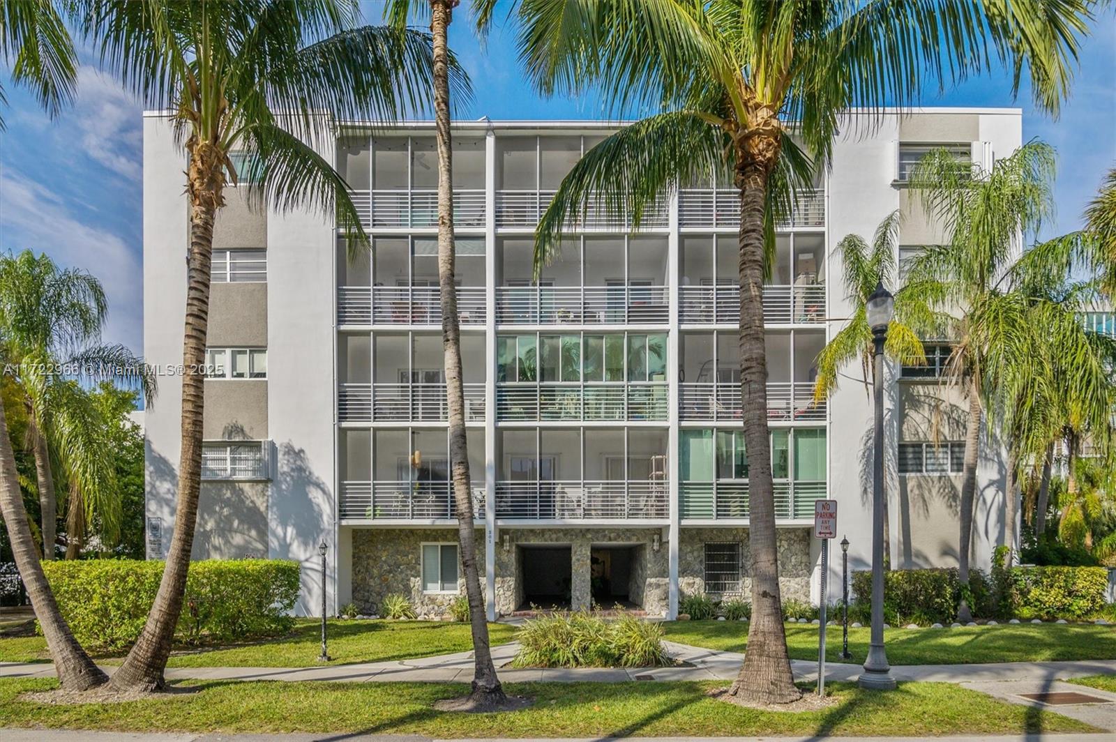 301 Sunrise Drive, Unit 3AW Key Biscayne, FL 33149 - Photo 2 of 23 a front view of multi story residential apartment building with yard and sign board