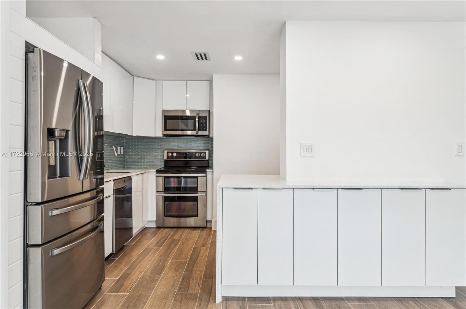 301 Sunrise Drive, Unit 3AW Key Biscayne, FL 33149 - Photo 4 of 23 a kitchen with stainless steel appliances a refrigerator and cabinets