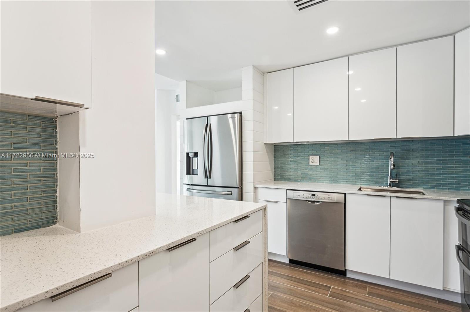 301 Sunrise Drive, Unit 3AW Key Biscayne, FL 33149 - Photo 5 of 23 a kitchen with granite countertop white cabinets and white appliances