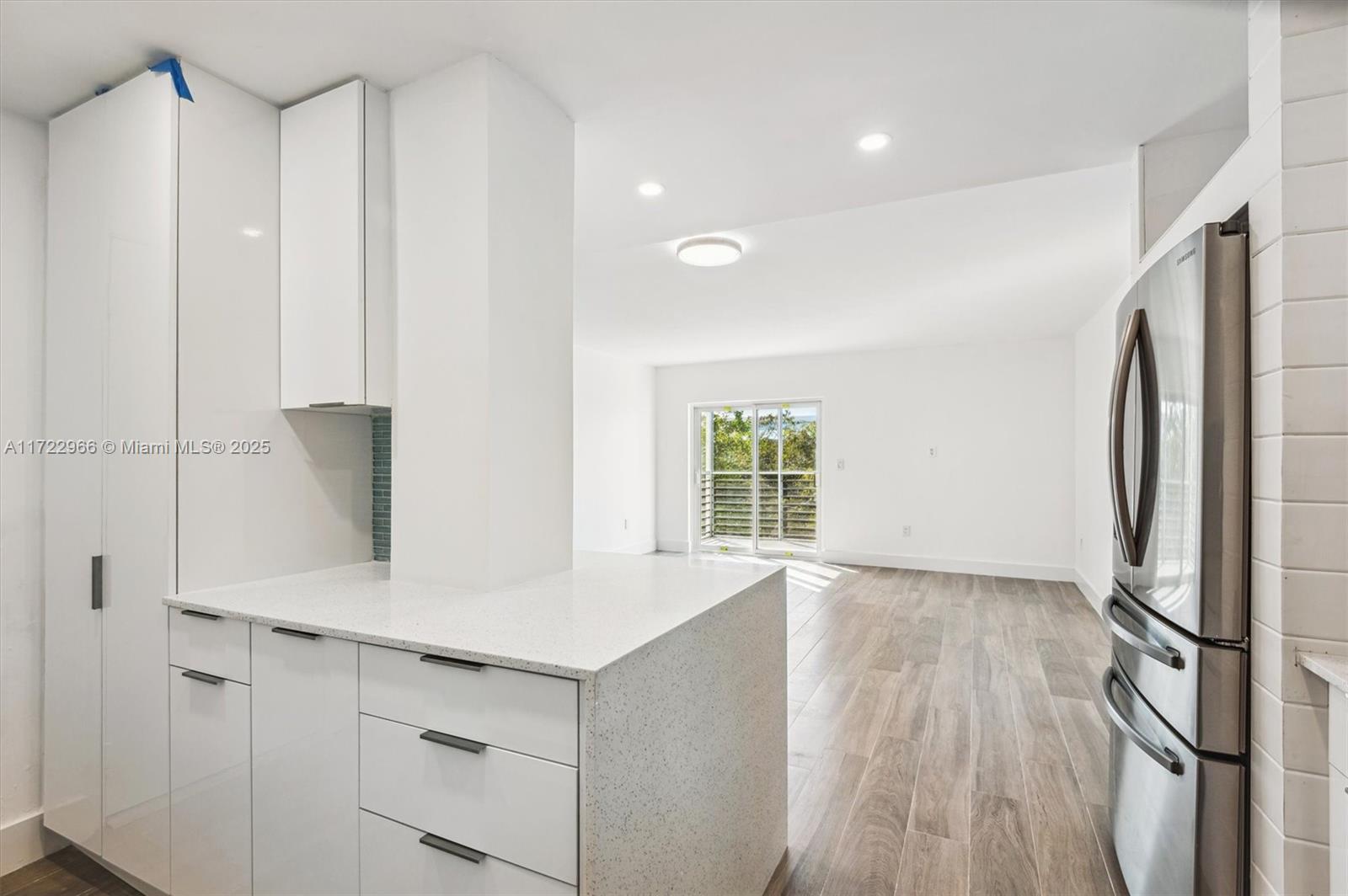 301 Sunrise Drive, Unit 3AW Key Biscayne, FL 33149 - Photo 6 of 23 a view of kitchen with stainless steel appliances cabinets and wooden floor
