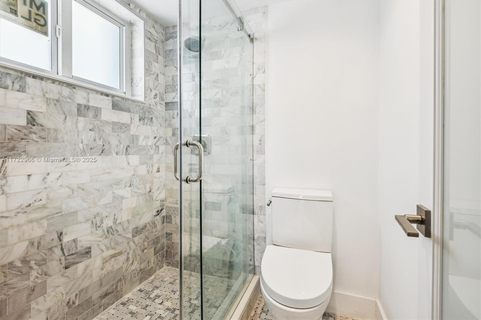 301 Sunrise Drive, Unit 3AW Key Biscayne, FL 33149 - Photo 9 of 23 a white toilet next to a bathroom
