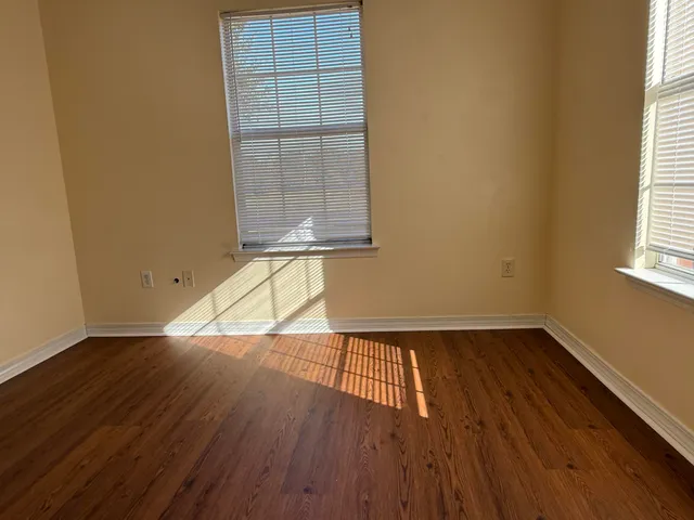 a view of wooden floor and windows in a room