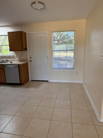 a large kitchen with stainless steel appliances and a refrigerator