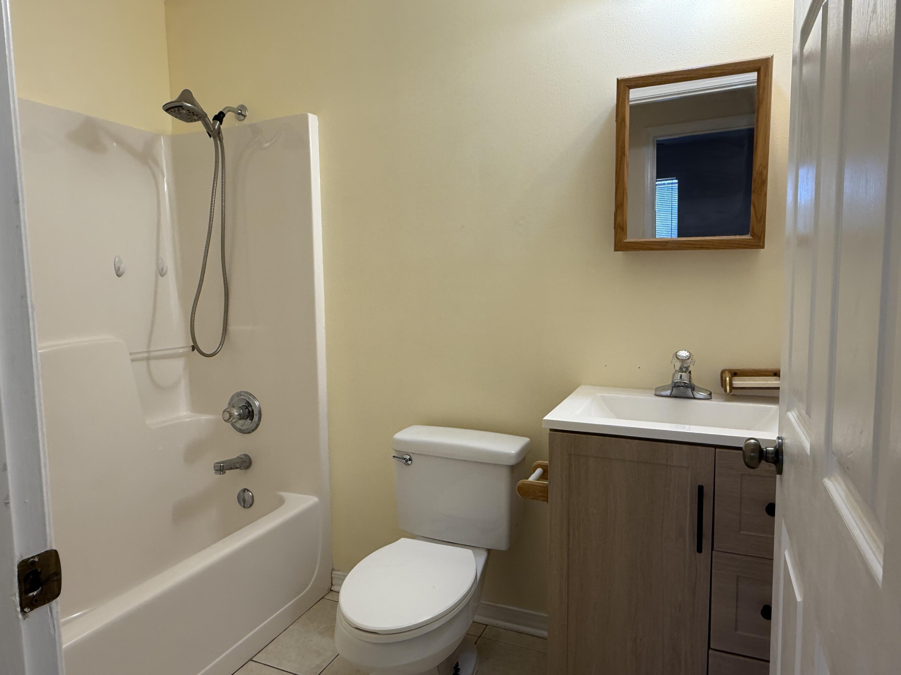 12341 Highway 90 Holt, FL 32564 - Photo 6 of 26 a bathroom with a sink a toilet and shower