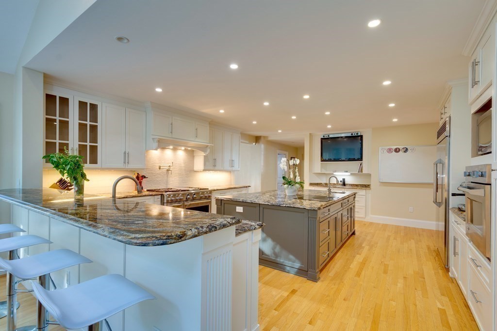 63 Brook Street Wellesley, MA 02482 - Photo 12 of 41 a kitchen with kitchen island granite countertop a stove and a sink