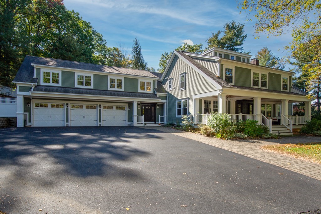 63 Brook Street Wellesley, MA 02482 - Photo 2 of 41 a view of a big house with a big yard and large trees