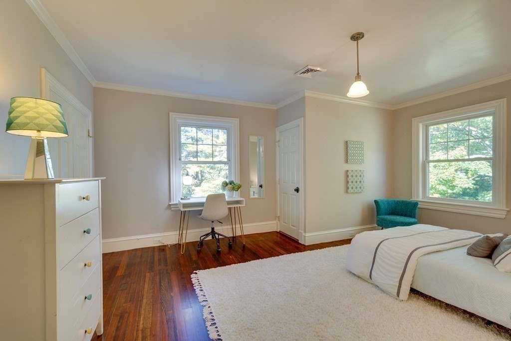 63 Brook Street Wellesley, MA 02482 - Photo 32 of 41 a bedroom with two beds and a chandelier