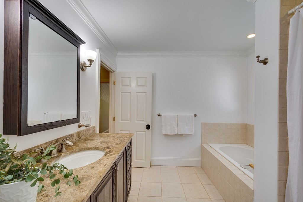 63 Brook Street Wellesley, MA 02482 - Photo 33 of 41 a bathroom with a granite countertop tub sink and mirror