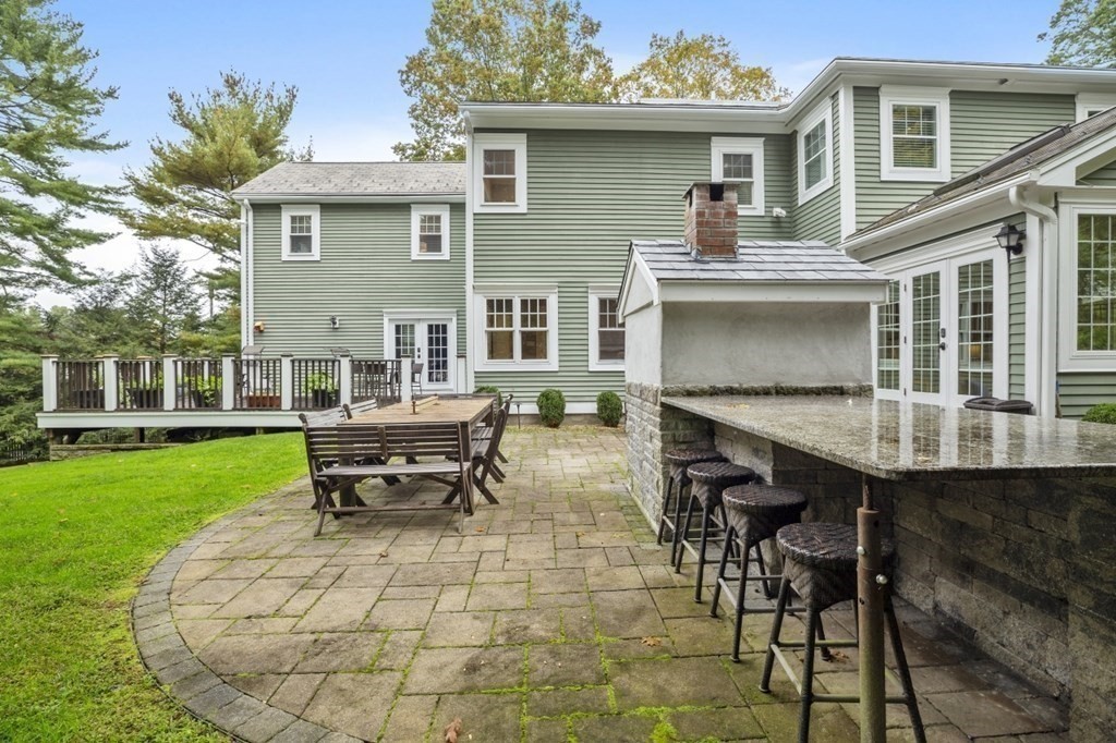 63 Brook Street Wellesley, MA 02482 - Photo 40 of 41 a view of a house with a backyard and a patio