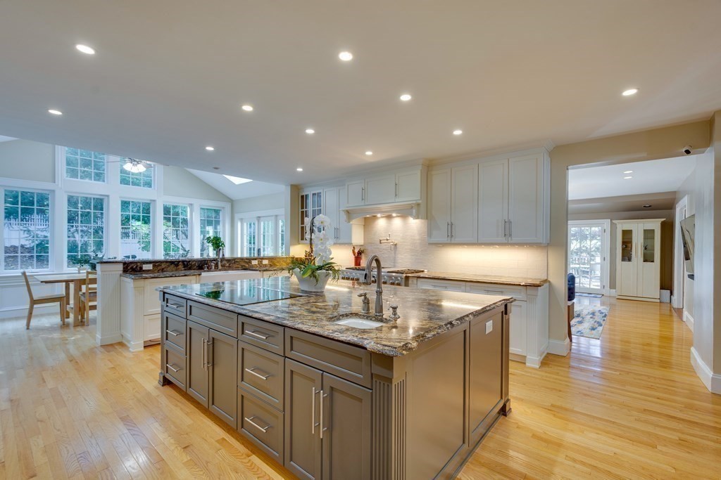 63 Brook Street Wellesley, MA 02482 - Photo 9 of 41 a kitchen with stainless steel appliances granite countertop a kitchen island a stove a sink a dining table and chairs