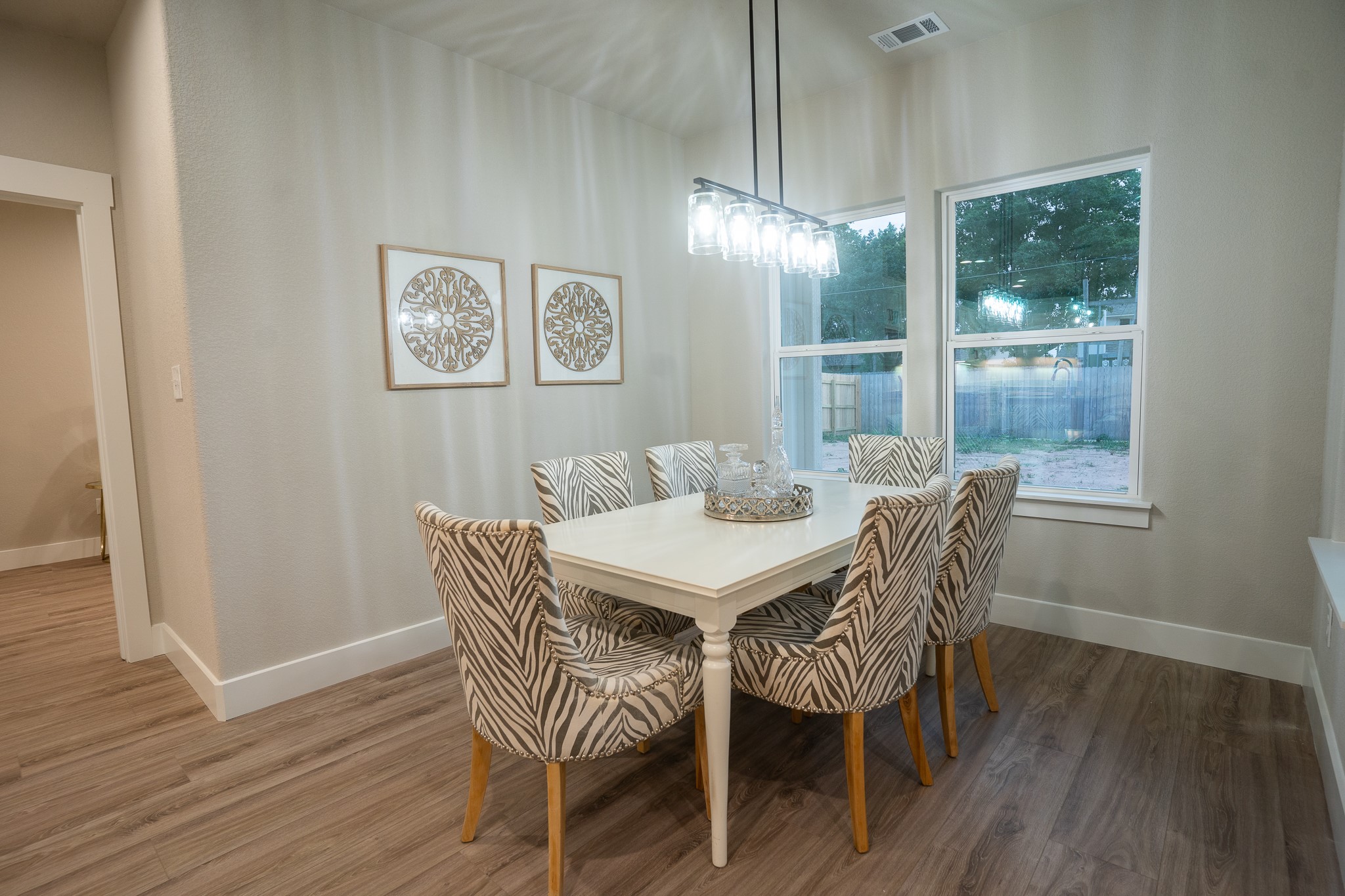 307 String Prairie Way Smithville, TX 78957 - Photo 18 of 34 a view of a dining room with furniture wooden floor and chandelier