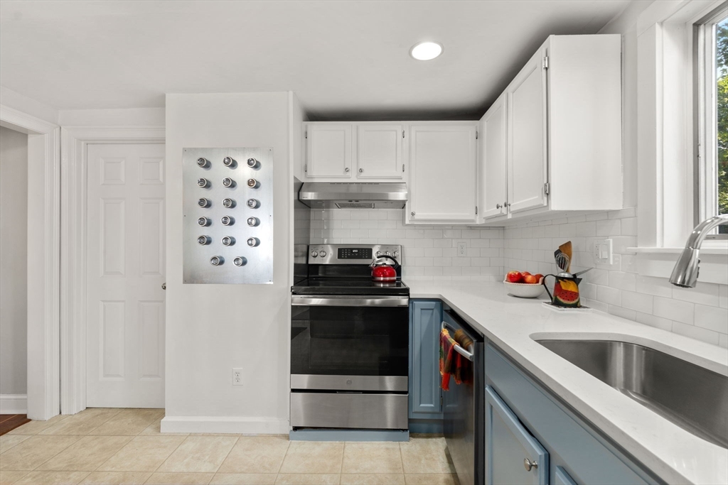 10 Prospect Street Maynard, MA 01754 - Photo 12 of 34 a kitchen with stainless steel appliances a stove a sink and a refrigerator