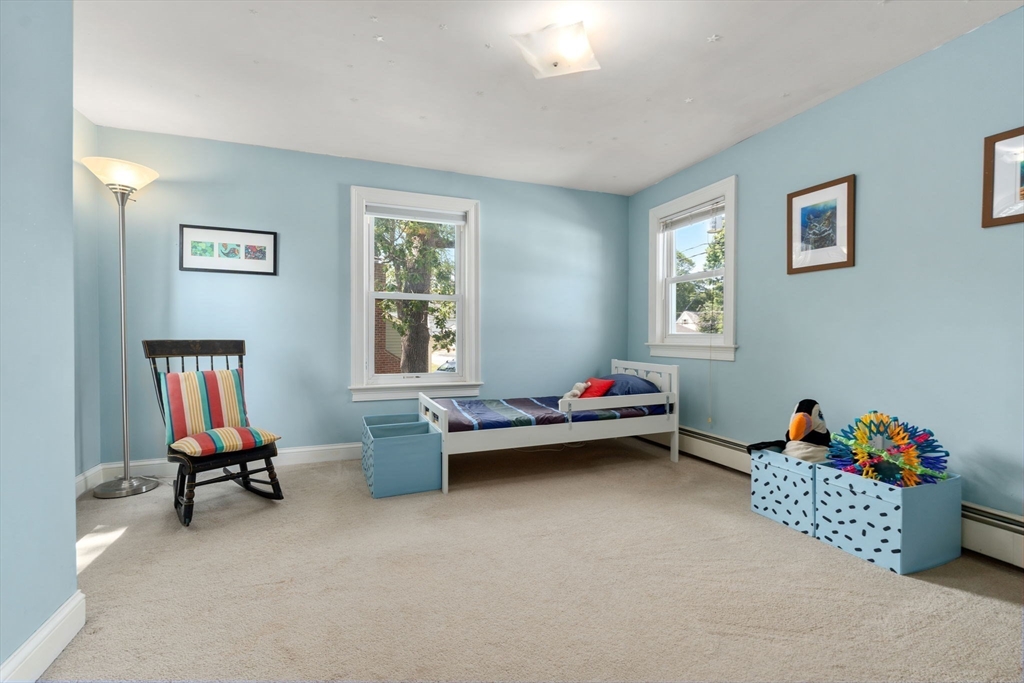 10 Prospect Street Maynard, MA 01754 - Photo 21 of 34 a living room with furniture stairs and a window