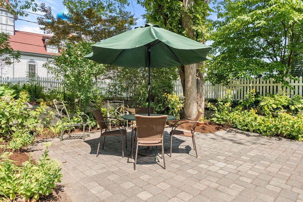 10 Prospect Street Maynard, MA 01754 - Photo 29 of 34 a patio table and chairs under an umbrella
