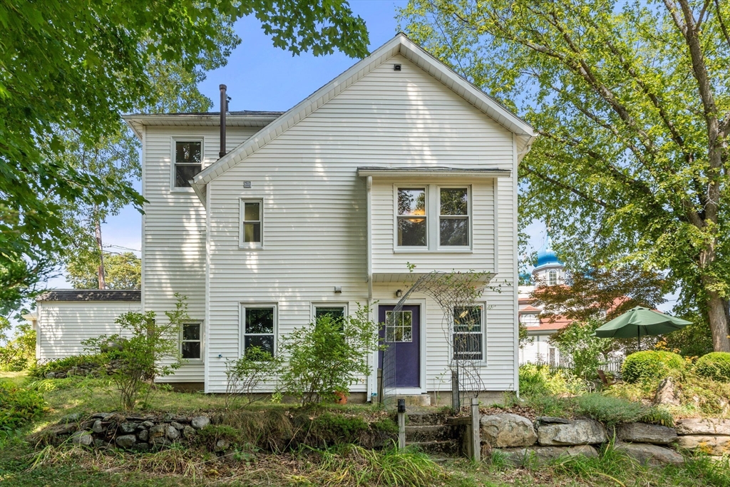 10 Prospect Street Maynard, MA 01754 - Photo 30 of 34 a view of a house with brick walls and plants