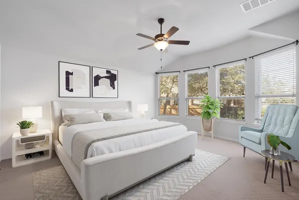 a bedroom with a large bed and a window