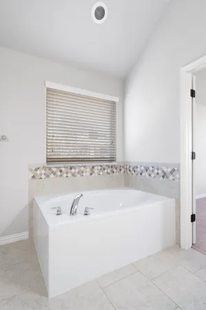 a bathroom with a bathtub and a sink
