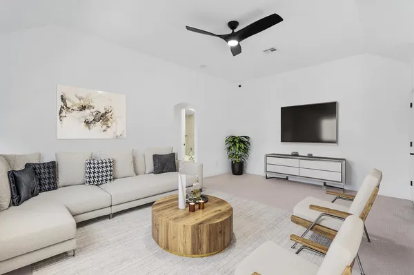 an empty room with closet and a ceiling fan
