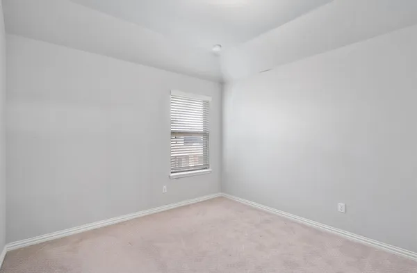 an empty room with closet area