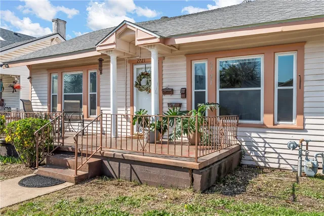 a view of house with a chairs and table in a patio
