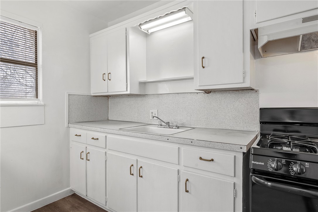 2721 Morrow Avenue Waco, TX 76707 - Photo 37 of 44 a kitchen with a stove and white cabinets