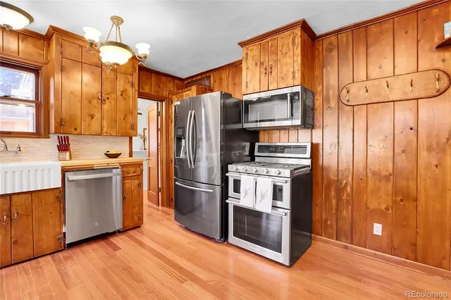 a kitchen with stainless steel appliances a refrigerator and a stove top oven