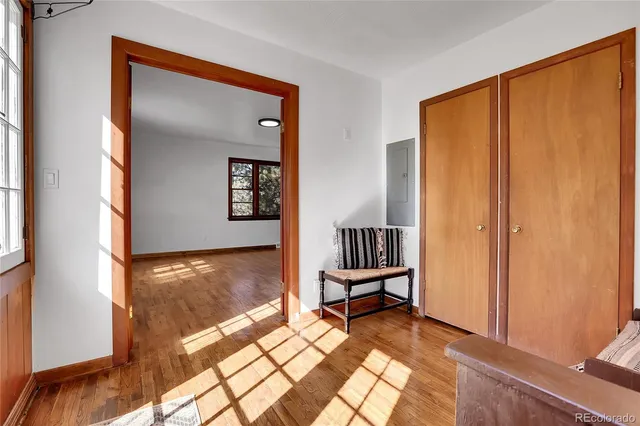 a view of a livingroom with wooden floor and a window