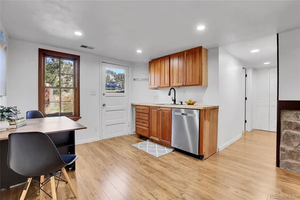 a hallway with cabinets and wooden floor