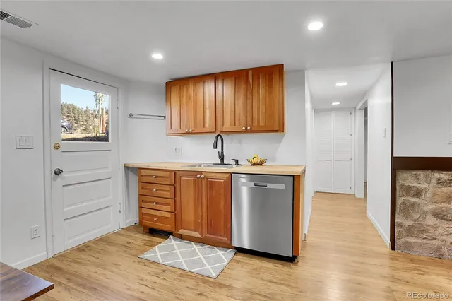 a living room with furniture a dining table wooden floor and a large window