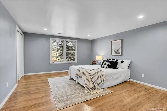 a big room with wooden floor and closet
