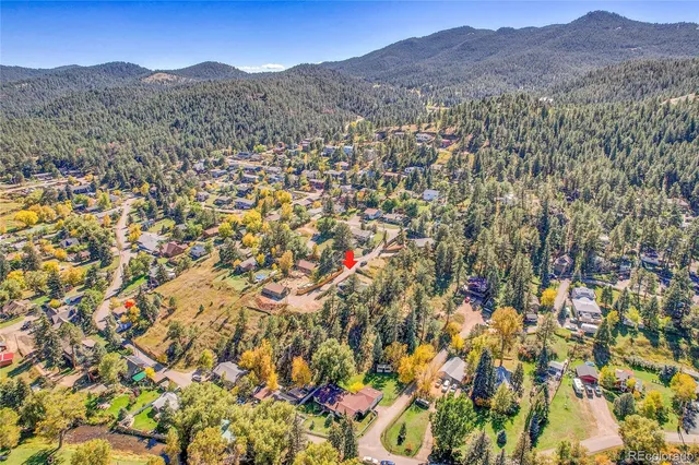 a view of a yard with wooden fence