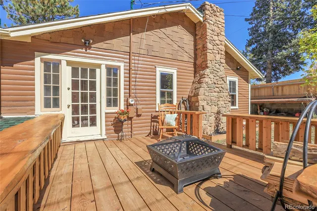 a view of a wooden chairs on the deck