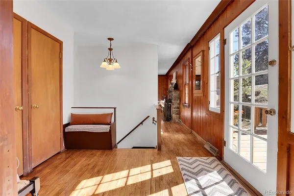 a view of a hallway with a couches and chandelier