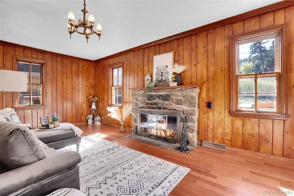a living room with furniture a fireplace and a window