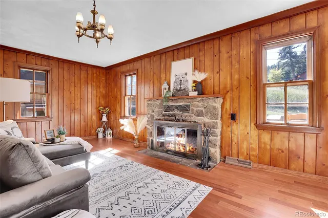 a living room with furniture a fireplace and a window