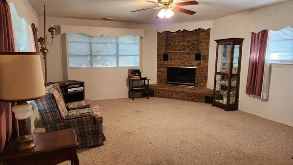 a view of a livingroom with furniture and a fireplace