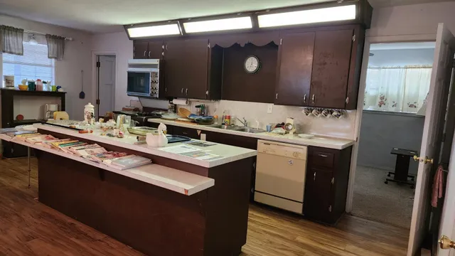 a utility room with a sink a vanity and a mirror