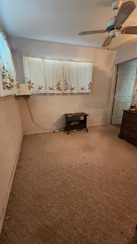 a view of a room with gym equipment and a view of living room