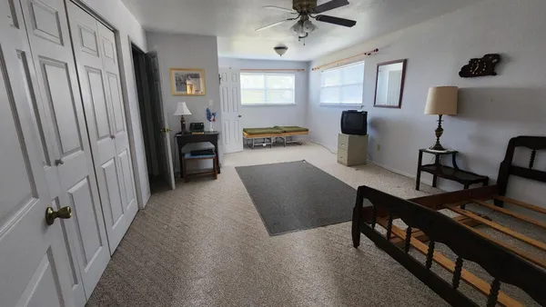 a view of a livingroom with furniture and a window