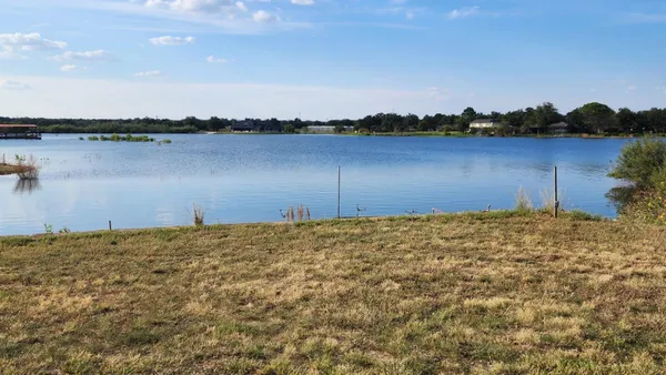 a view of a lake with houses in the background