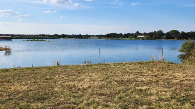 a view of a lake with houses in the background