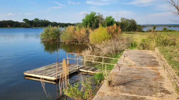 a view of a lake with houses in the background