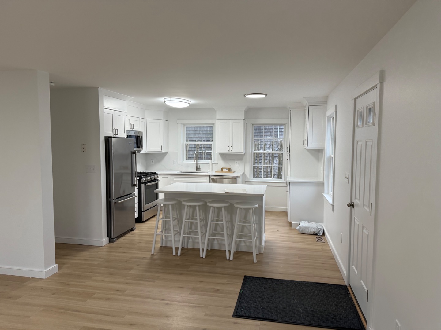 106 Old South Road, Unit A B Nantucket, MA 02554 - Photo 8 of 24 a kitchen with a sink stainless steel appliances and cabinets