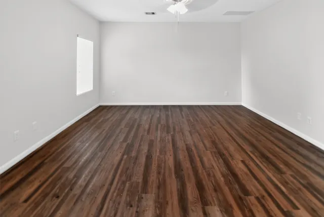 a view of a room with wooden floor and window