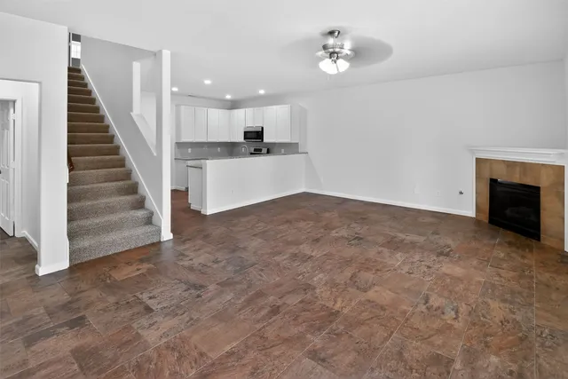 a view of a kitchen with furniture and a ceiling fan